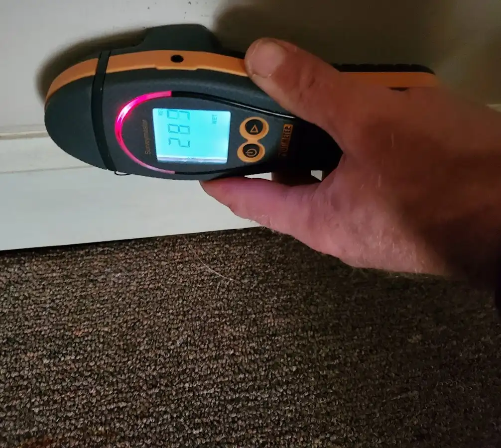 Moisture detection at baseboard during Storm Damage Restoration in Turpin Hills